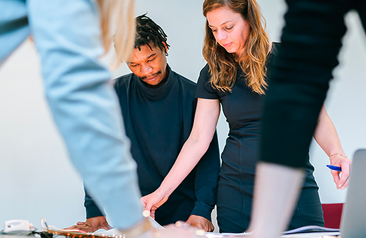 Coworkers collaborating over documents at a table